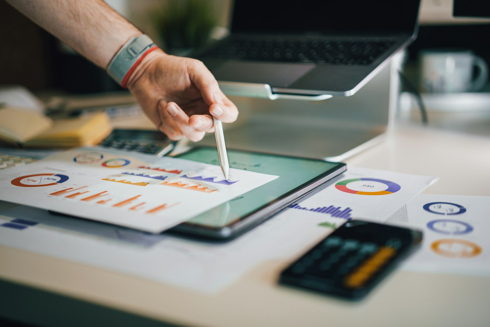 SEO cost in Singapore pricing analysis with charts, calculator, and laptop